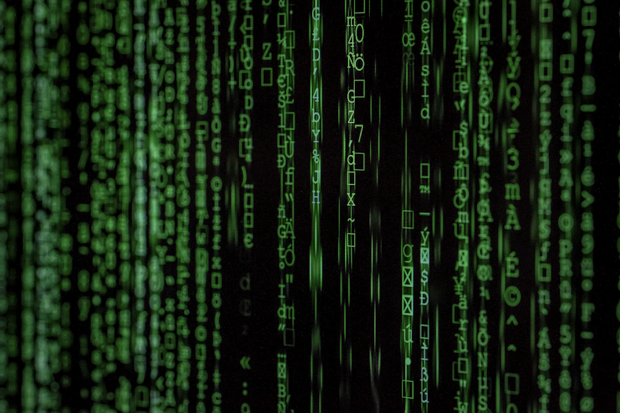 Linhas de código em verde sobre fundo escuro, representando desenvolvimento de software
